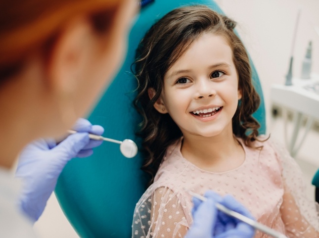 Young girl smiling at her dentist