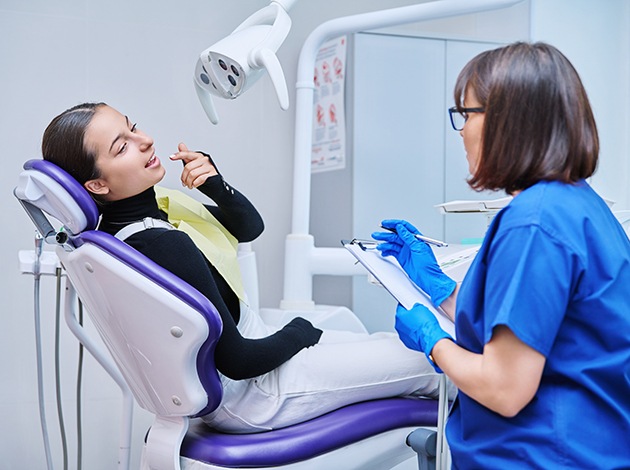 Teenage patient talking with dental team member