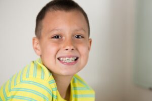 Young boy with braces smiling