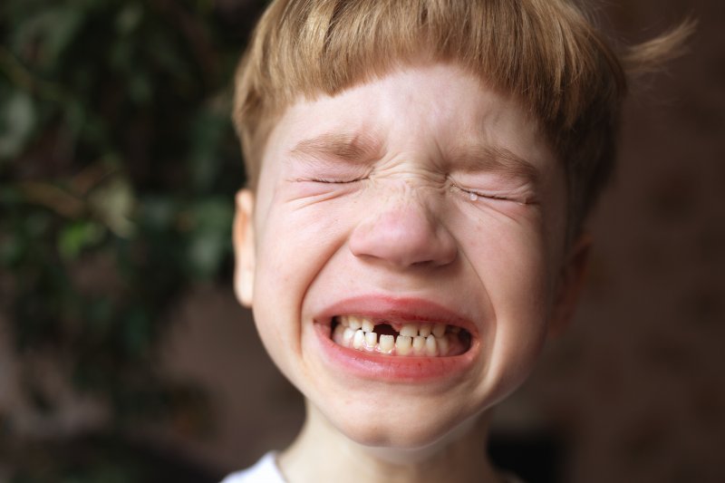 little boy dealing with a dental emergency